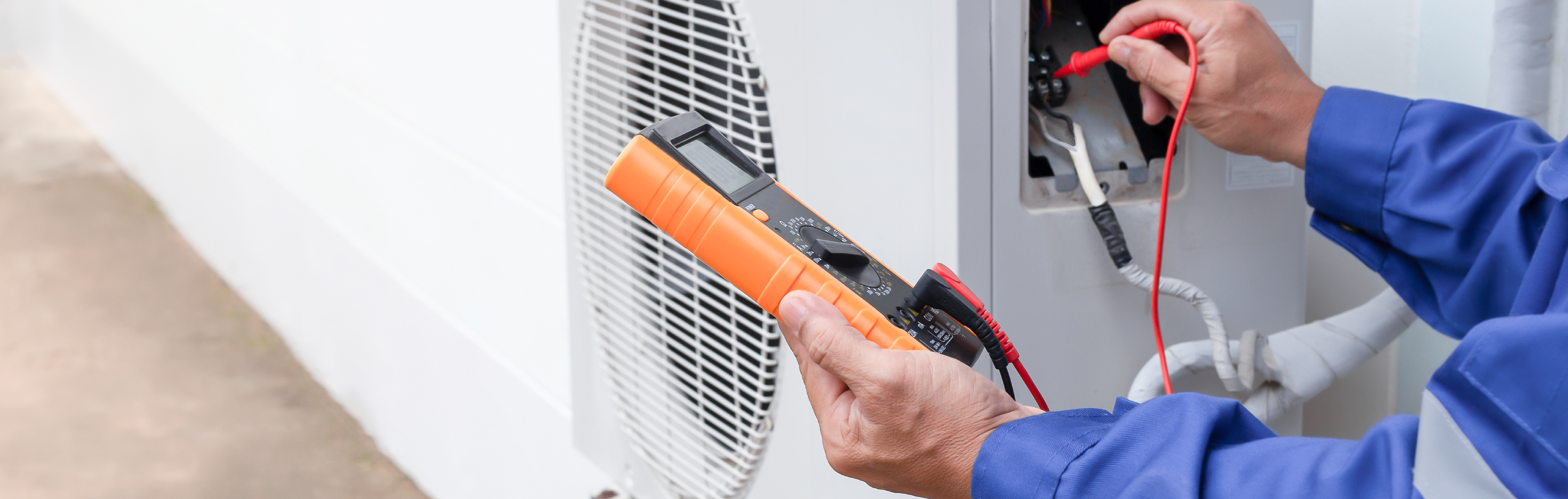 man using instrument to check HVAC unit