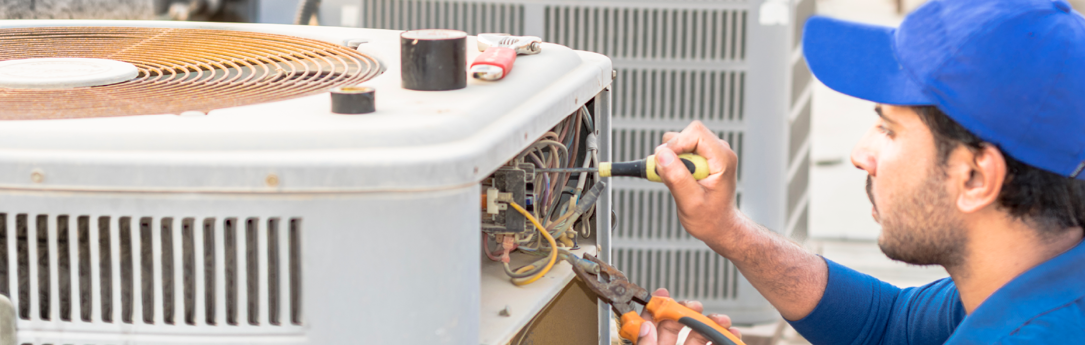 Chancey & Reynolds HVAC technician looking at a residential HVAC unit