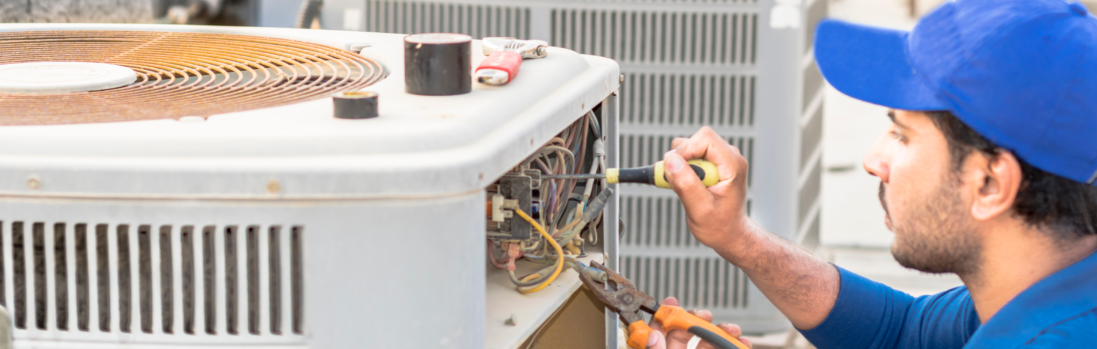 Chancey & Reynolds HVAC technician looking at a residential HVAC unit
