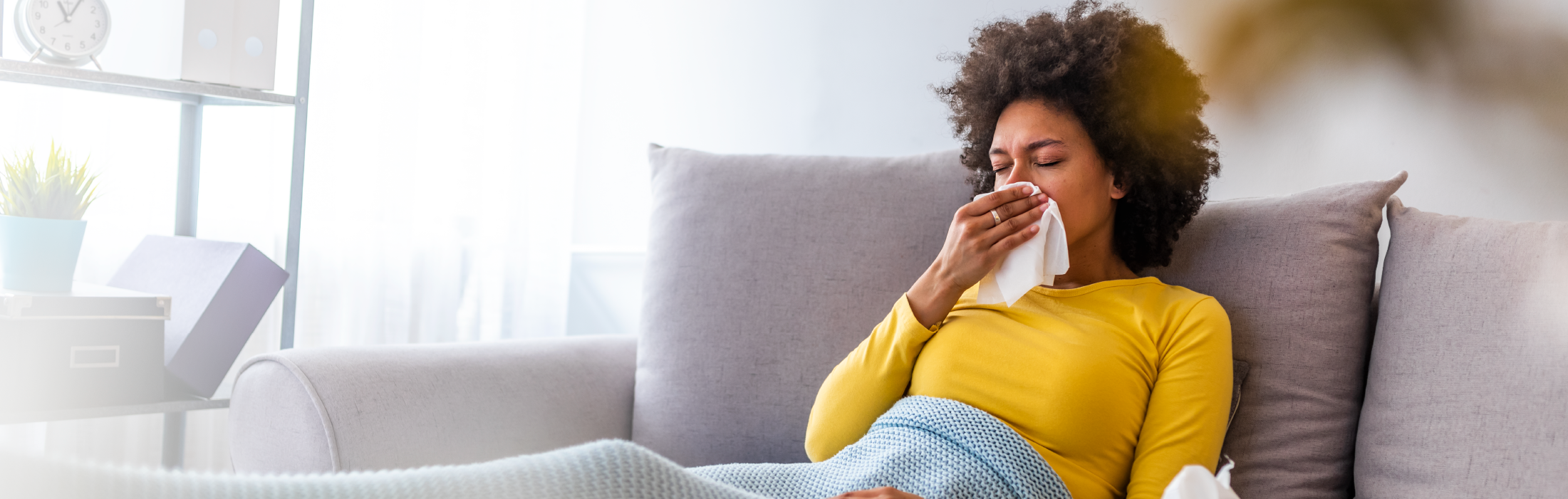 Attractive African-American women in yellow sweater breathing bad indoor air