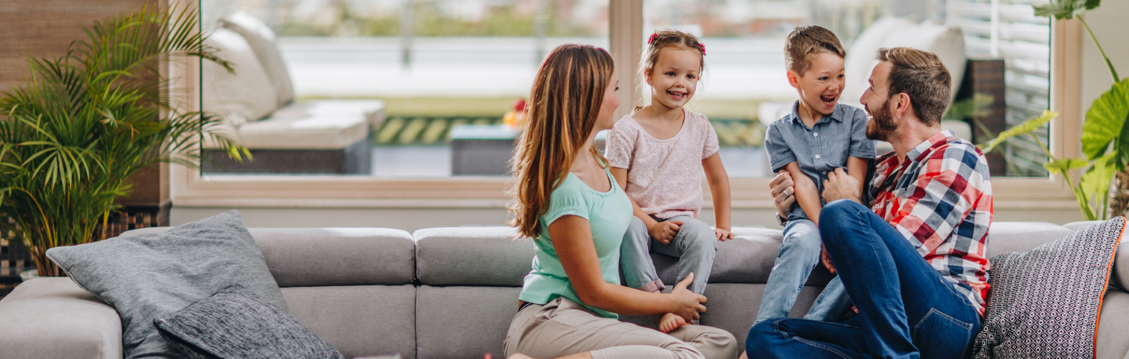 Happy family in a living room sitting on a couch