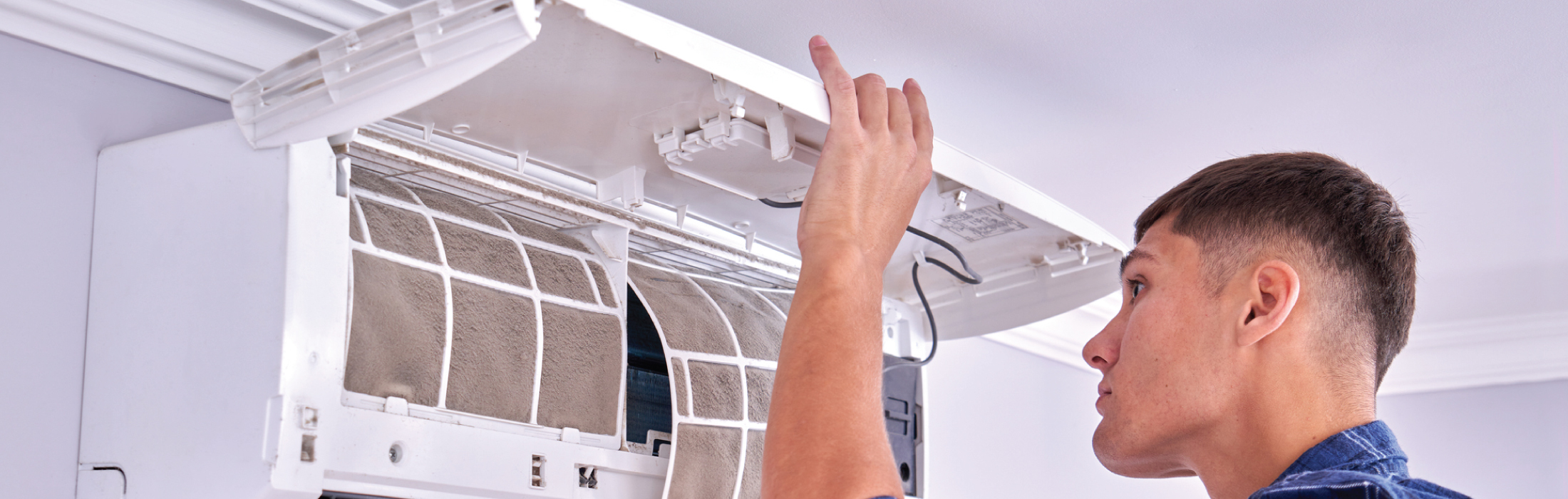 HVAC Technician looking at HVAC filter system