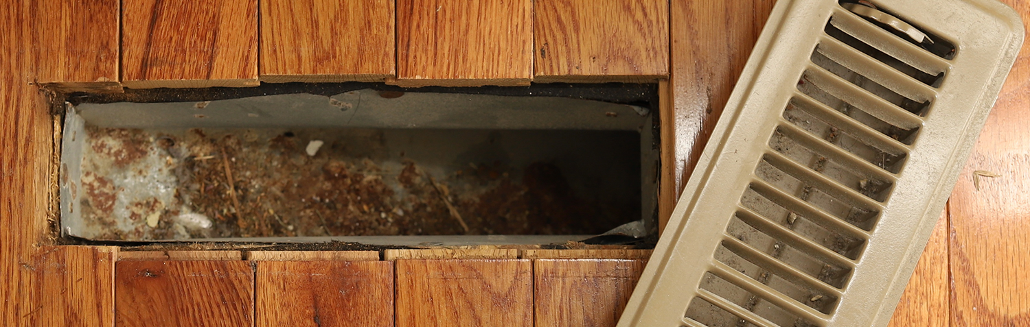 A opened heating/cooling vent register on the floor in a home home