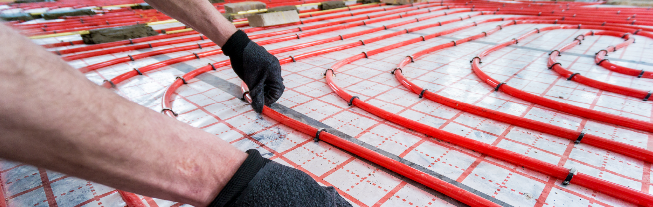 Pipefitter install system of underfloor heating system at home.